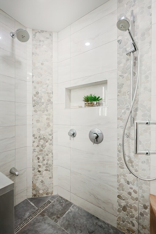 bathroom with a tile shower