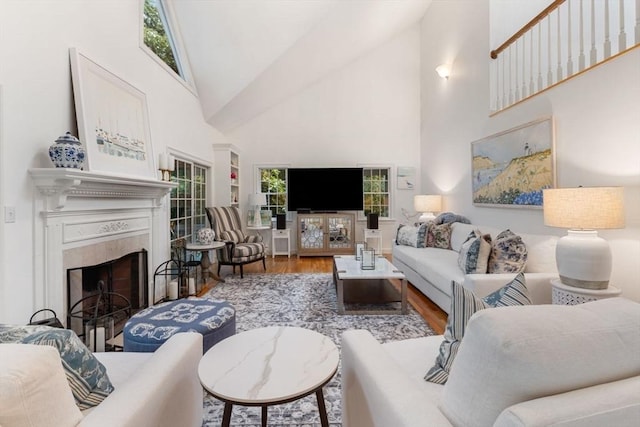 11 Forest Ln Unit 11, Scituate, MA 02066 - living room featuring high vaulted ceiling, wood finished floors, a fireplace, and healthy amount of natural light