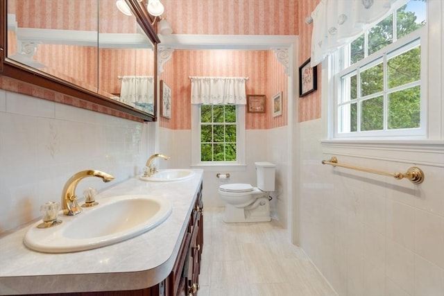 11 Forest Ln Unit 11, Scituate, MA 02066 - full bathroom with wallpapered walls, double vanity, tile walls, and a wainscoted wall