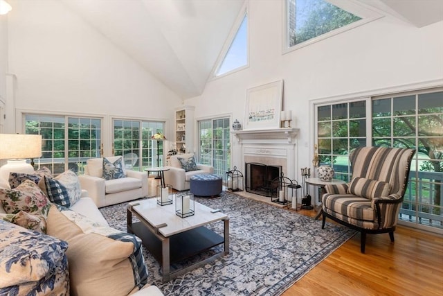 11 Forest Ln Unit 11, Scituate, MA 02066 - living area featuring a towering ceiling, healthy amount of natural light, wood finished floors, and a high end fireplace