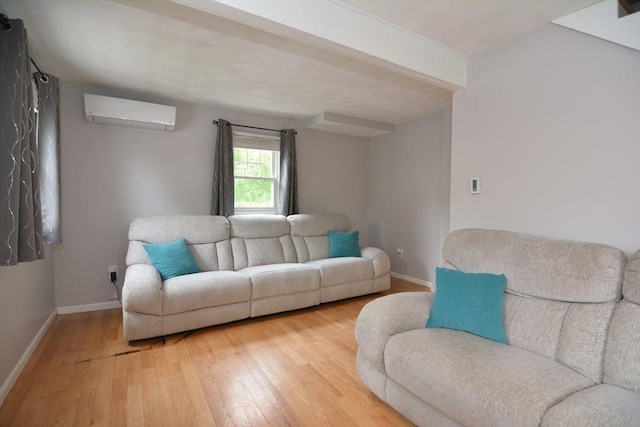 living area with a wall unit AC, light wood-type flooring, and baseboards