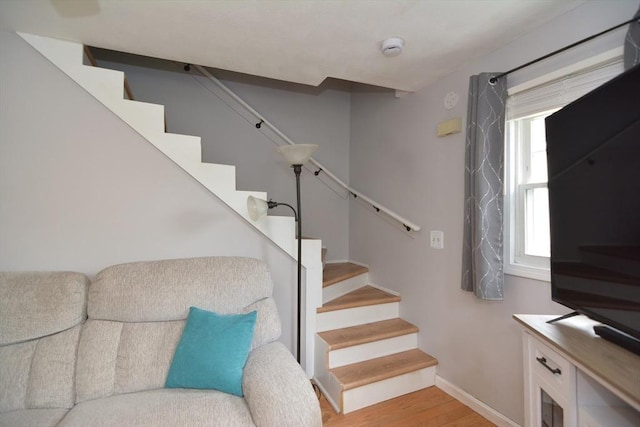 stairs with wood finished floors and baseboards