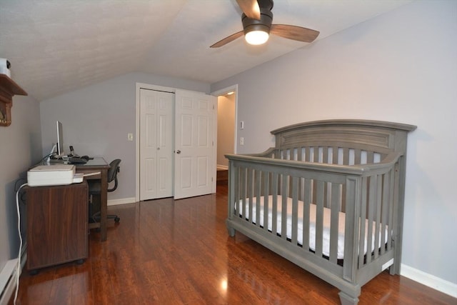 bedroom featuring a desk, lofted ceiling, a closet, wood finished floors, and baseboards