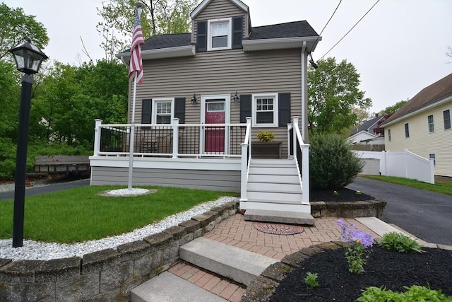 rear view of property featuring a yard