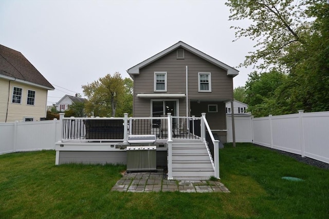back of property with a deck and a patio area