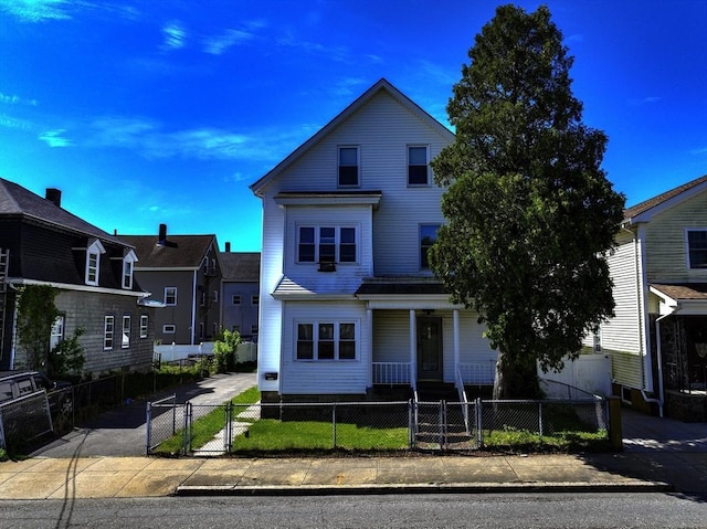 405 Warren St, Fall River, MA 02721 - traditional-style home featuring a porch, a gate, and a fenced front yard