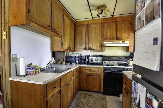 405 Warren St, Fall River, MA 02721 - kitchen featuring range with gas stovetop, a sink, under cabinet range hood, refrigerator, and black microwave