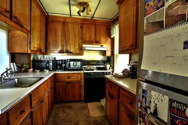 405 Warren St, Fall River, MA 02721 - kitchen with gas range oven, under cabinet range hood, a sink, black microwave, and light countertops