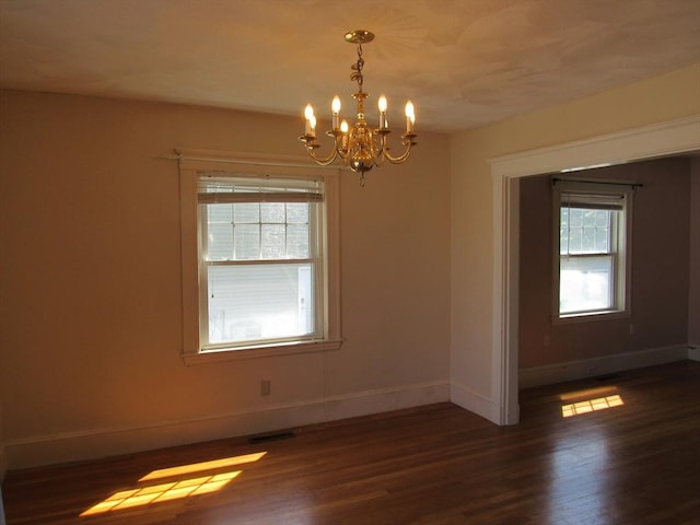 49 Vassall St, Quincy, MA 02170 - unfurnished room featuring plenty of natural light, dark wood-style floors, and a chandelier