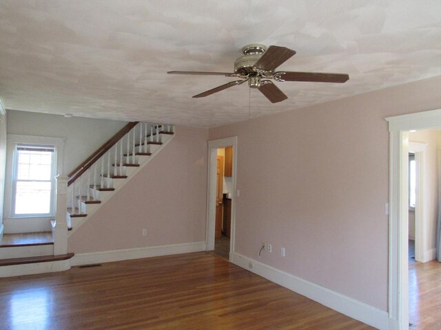 49 Vassall St, Quincy, MA 02170 - unfurnished living room with stairs, wood finished floors, and ceiling fan