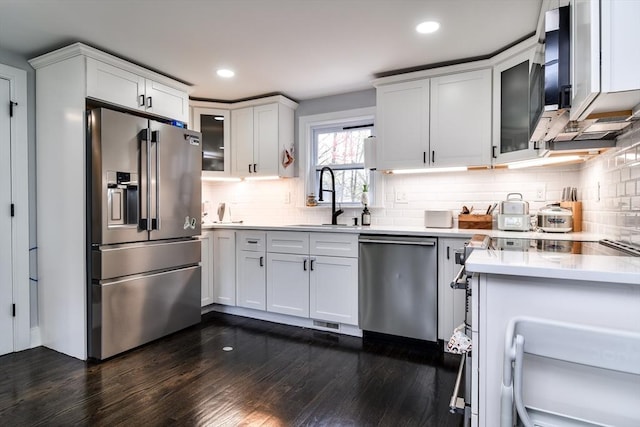 8 Lee Rd, Sharon, MA 02067 - kitchen with stainless steel appliances, light countertops, white cabinets, a sink, and dark wood-style floors