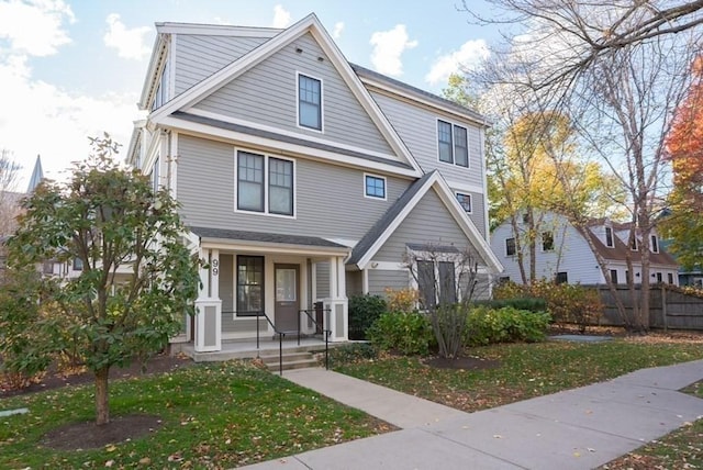 view of front facade with covered porch and a front yard