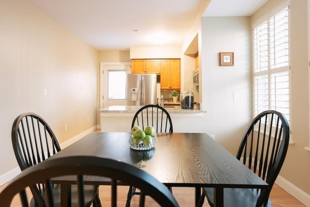 dining space with light hardwood / wood-style floors