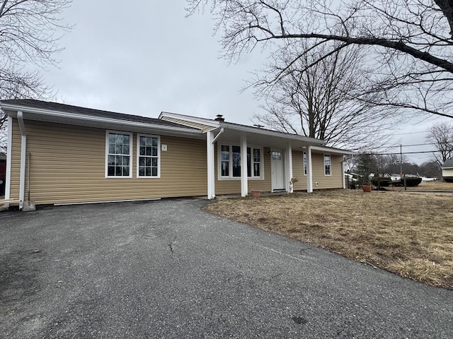 single story home featuring aphalt driveway