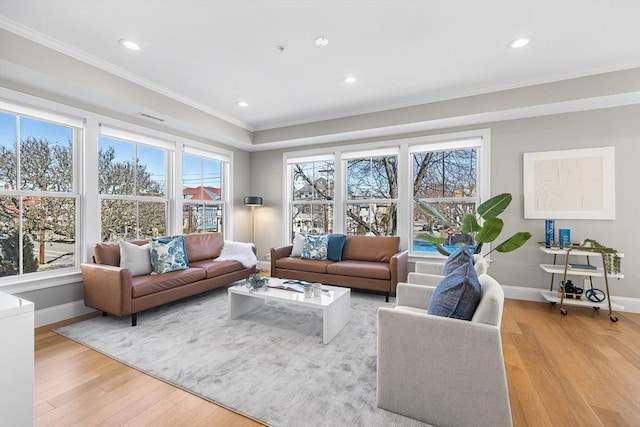 living room featuring recessed lighting, crown molding, light wood-type flooring, and baseboards