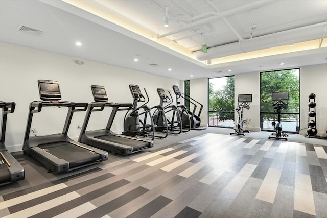 workout area with carpet and a wall of windows