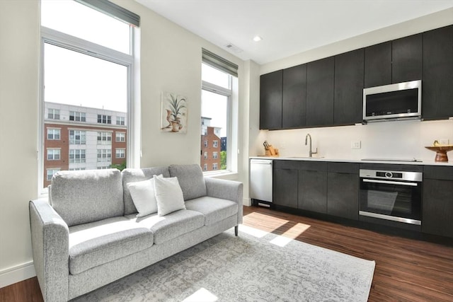 interior space with dark hardwood / wood-style flooring, sink, and a wealth of natural light