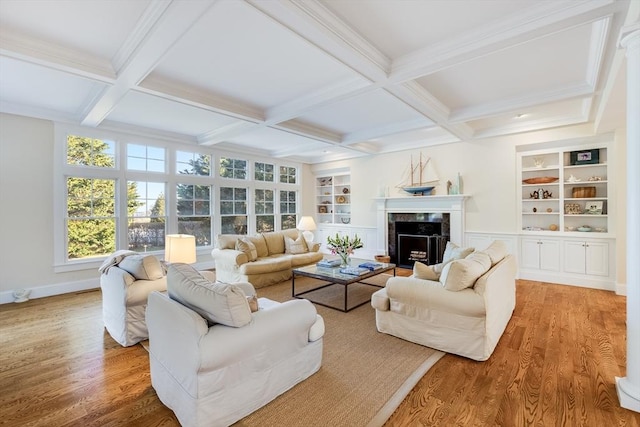 living room with beamed ceiling, a fireplace, coffered ceiling, and hardwood / wood-style floors