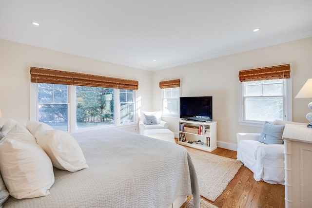 bedroom with hardwood / wood-style flooring and ornamental molding