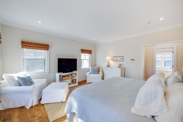 bedroom featuring crown molding and light hardwood / wood-style floors