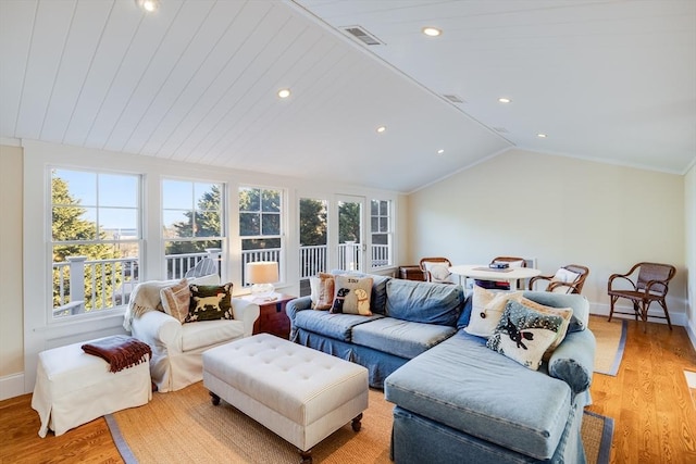 living room featuring crown molding, lofted ceiling, and light wood-type flooring