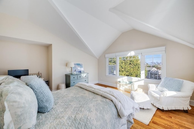 bedroom with lofted ceiling and hardwood / wood-style flooring