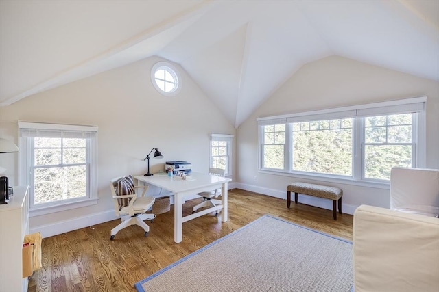 home office with hardwood / wood-style flooring and vaulted ceiling