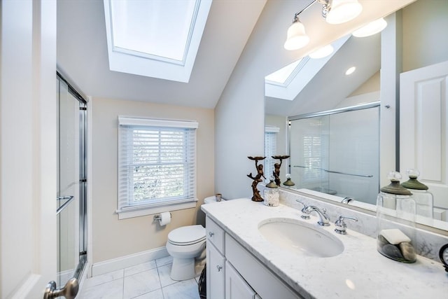 bathroom featuring vanity, a shower with door, lofted ceiling with skylight, and toilet