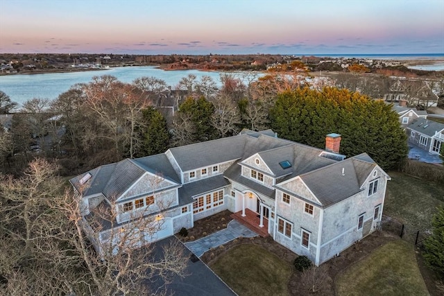 aerial view at dusk with a water view