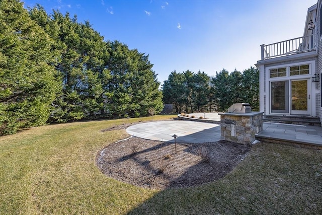 view of yard with area for grilling, a patio, and a balcony