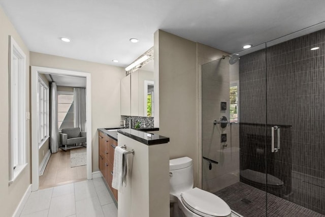 full bathroom featuring a stall shower, healthy amount of natural light, toilet, vanity, and recessed lighting