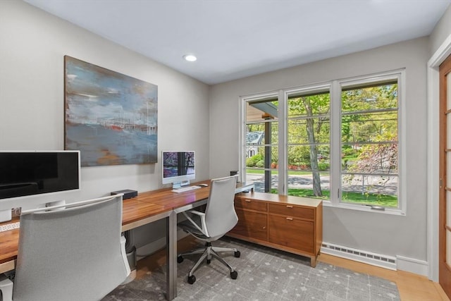office space featuring a baseboard heating unit, recessed lighting, and baseboards