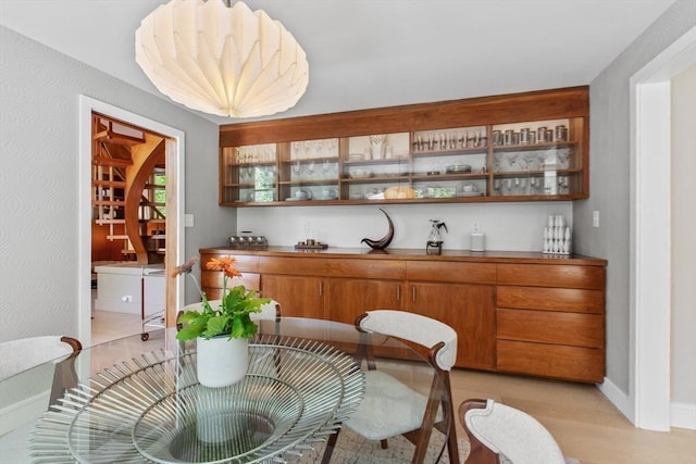 dining room featuring light wood-style floors and baseboards