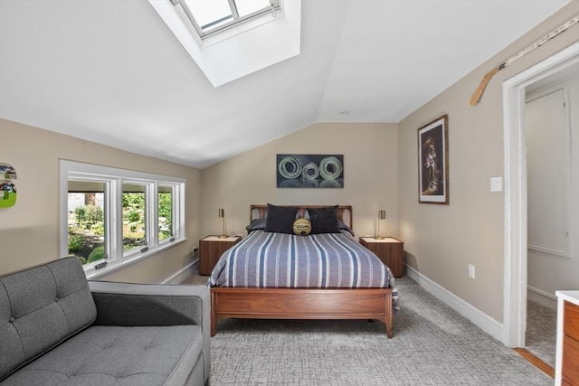 bedroom with a skylight, vaulted ceiling, baseboards, and carpet flooring
