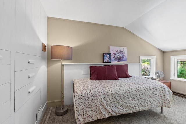 carpeted bedroom with vaulted ceiling and baseboards