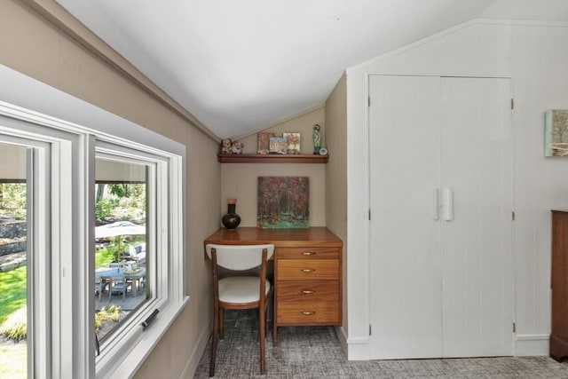 office space with lofted ceiling and light colored carpet