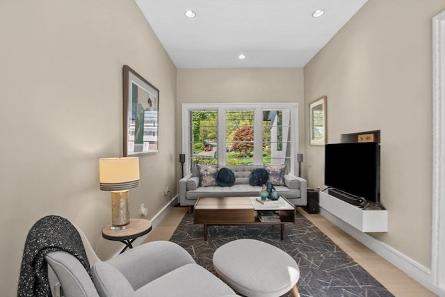 living area featuring recessed lighting and baseboards