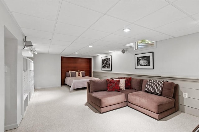 carpeted living area featuring a drop ceiling and recessed lighting