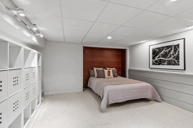 carpeted bedroom featuring recessed lighting and a paneled ceiling
