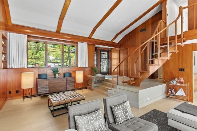 living room featuring wood walls and stairs