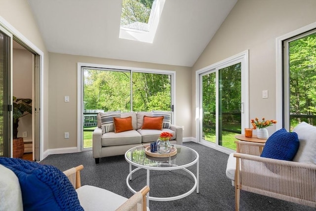sunroom with vaulted ceiling, a skylight, and plenty of natural light