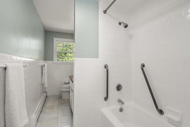 bathroom with baseboard heating, toilet, a wainscoted wall, and tile walls