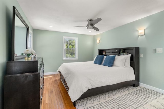bedroom with baseboards, a ceiling fan, wood-type flooring, and recessed lighting