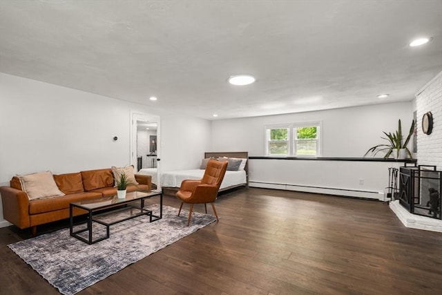 living area with baseboard heating, dark wood-style flooring, and recessed lighting