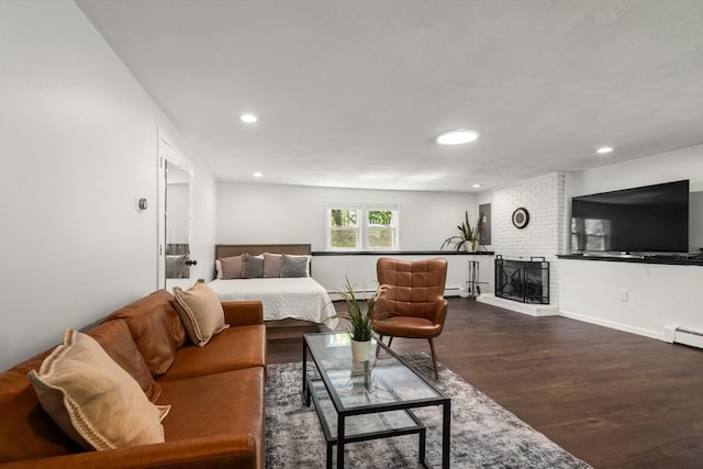 living room featuring dark wood finished floors, recessed lighting, a fireplace, baseboards, and baseboard heating