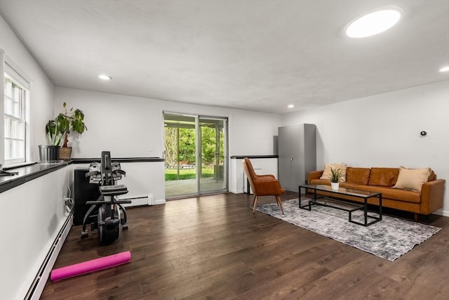 living area with a baseboard heating unit, dark wood finished floors, and recessed lighting