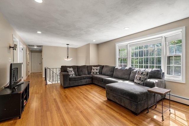 living room with light wood-style flooring, recessed lighting, and baseboard heating