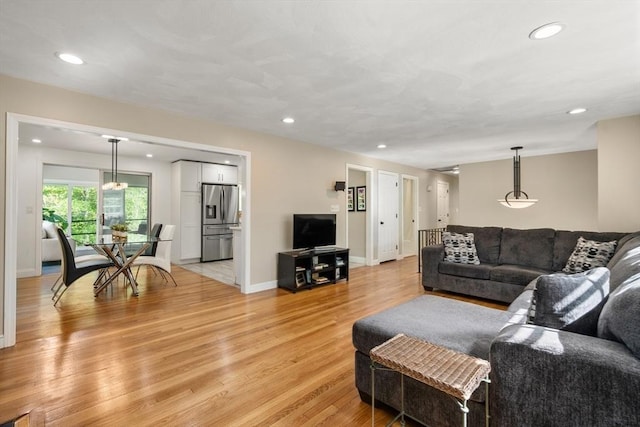living area with light wood finished floors, recessed lighting, and baseboards