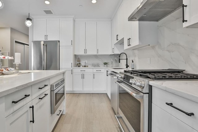18 Artisan Dr Unit 208, Salem, NH 03079 - kitchen with appliances with stainless steel finishes, a sink, under cabinet range hood, white cabinetry, and backsplash