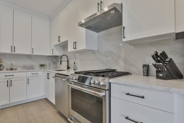 18 Artisan Dr Unit 208, Salem, NH 03079 - kitchen with appliances with stainless steel finishes, under cabinet range hood, a sink, white cabinetry, and backsplash